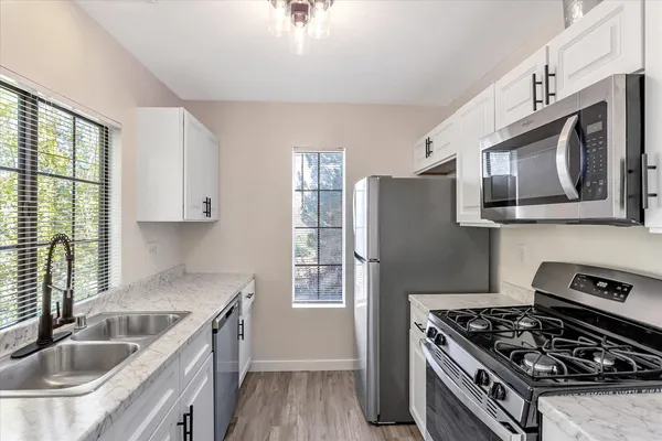 a kitchen with granite countertop a sink and a window