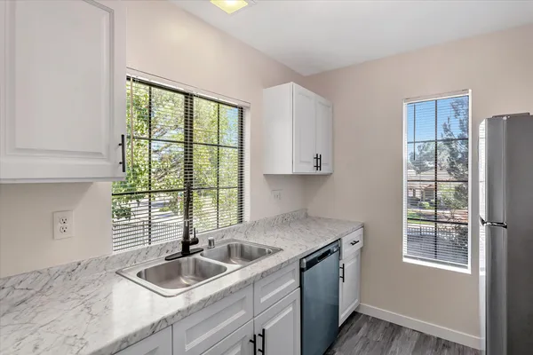 a kitchen with stainless steel appliances a stove a microwave and a refrigerator