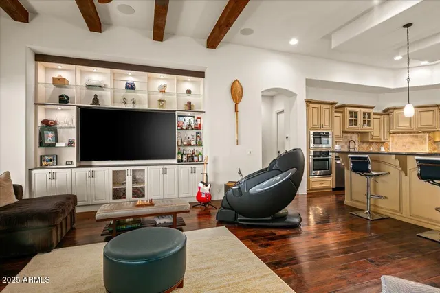 a kitchen with stainless steel appliances granite countertop a stove a refrigerator a oven a sink with island chairs and wooden floor