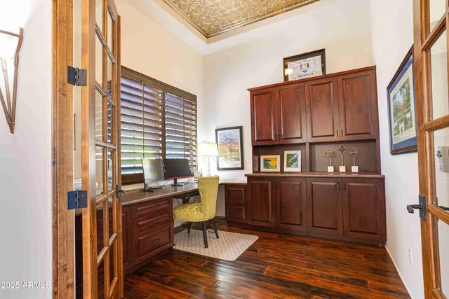 a view of a patio with table and chairs potted plants and large tree