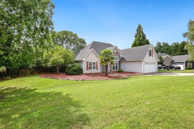 a front view of a house with garden