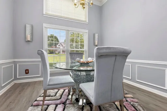 a view of a dining room with furniture window and wooden floor