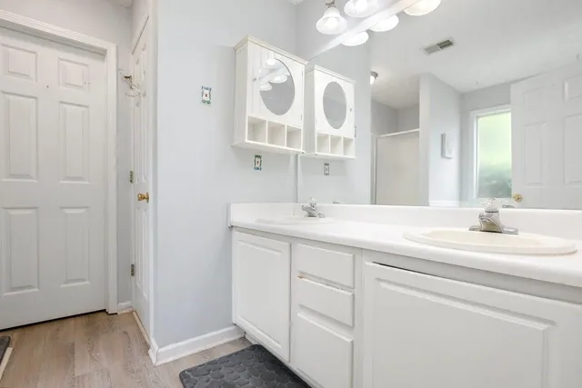 a bathroom with a sink vanity and mirror