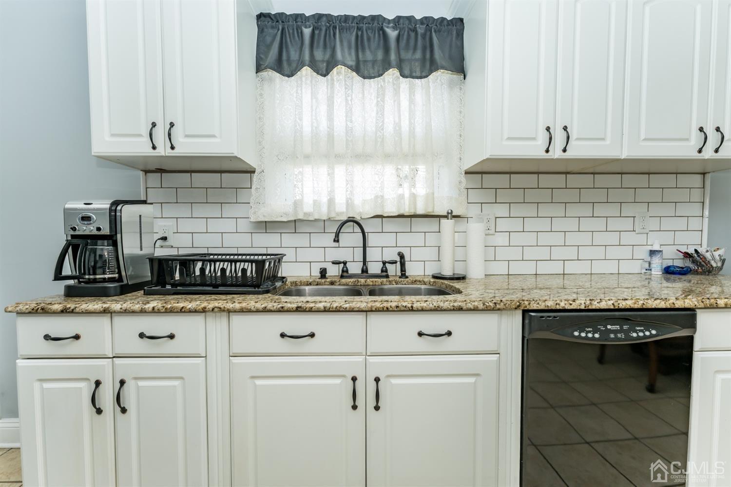 226 Hillside Road Linden, NJ 07036 - Photo 14 of 31 a kitchen with granite countertop white cabinets and a sink