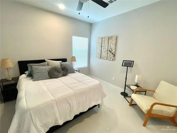 a bedroom with a bed couch and window