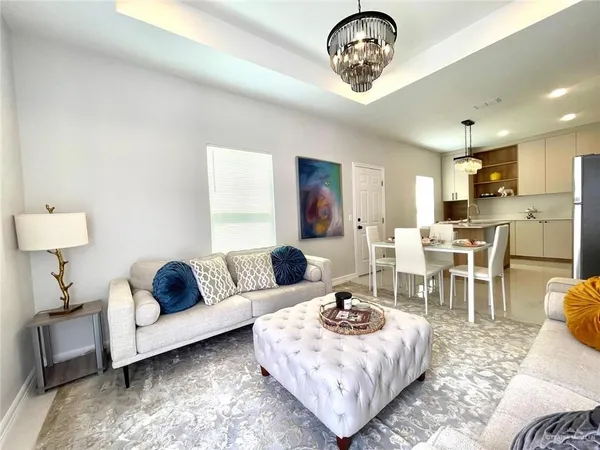 a living room with furniture rug and window