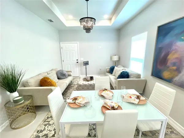 a living room with furniture and a chandelier
