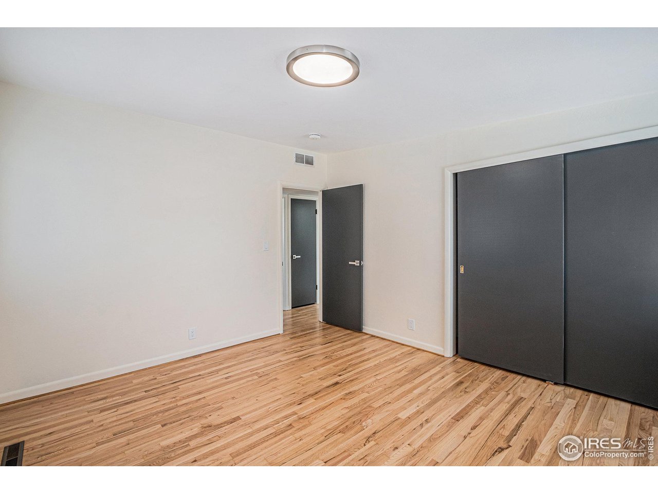 613 Skyline Drive Fort Collins, CO 80521 - Photo 13 of 19 a view of an empty room with wooden floor