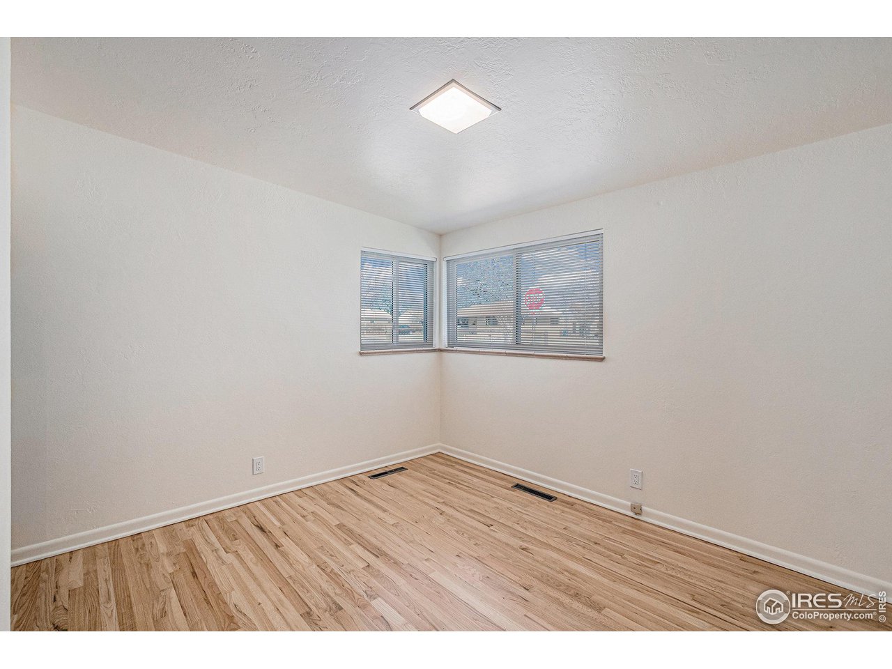 613 Skyline Drive Fort Collins, CO 80521 - Photo 15 of 19 a view of an empty room with wooden floor