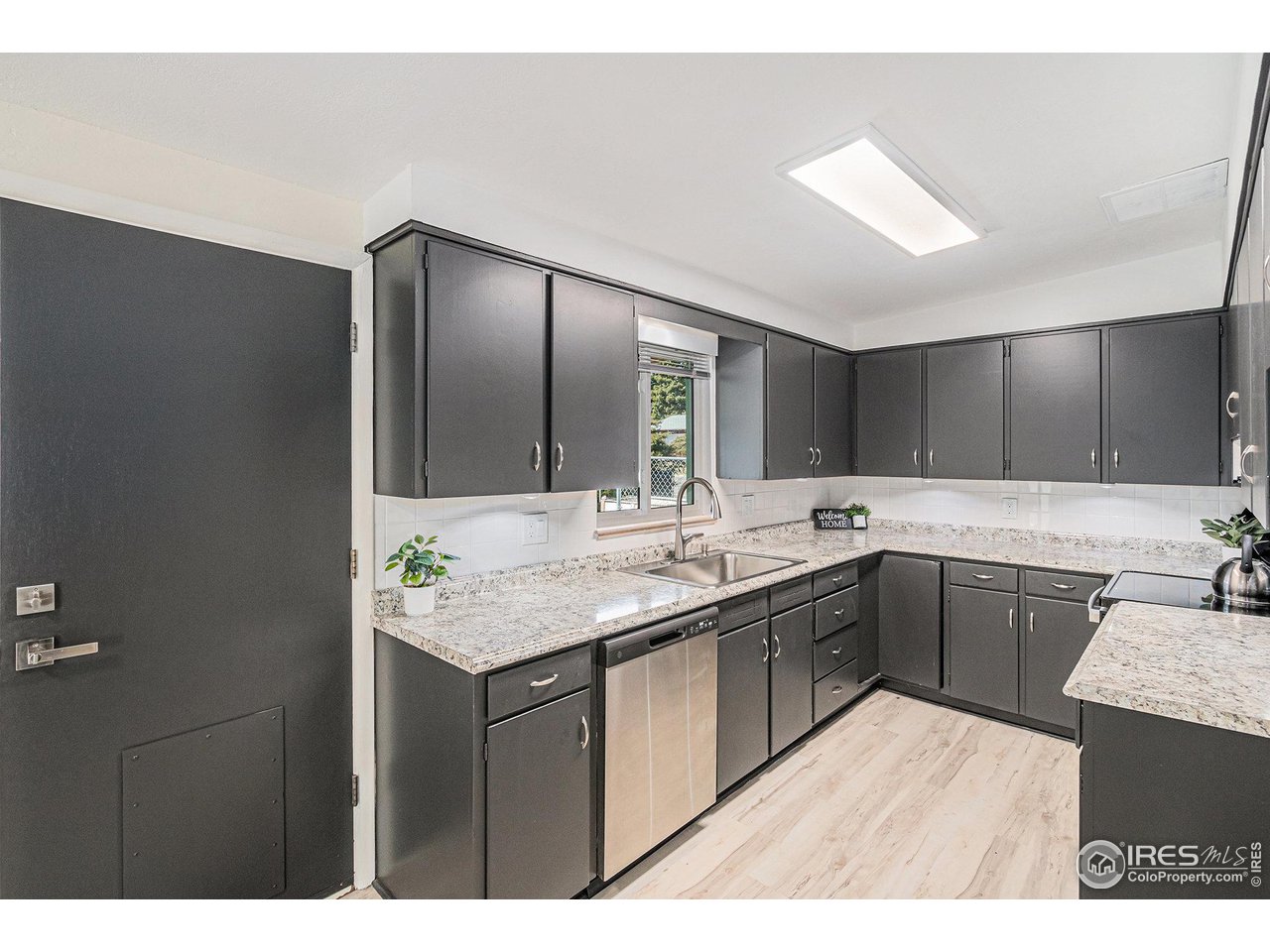 613 Skyline Drive Fort Collins, CO 80521 - Photo 6 of 19 a kitchen with a sink and cabinets