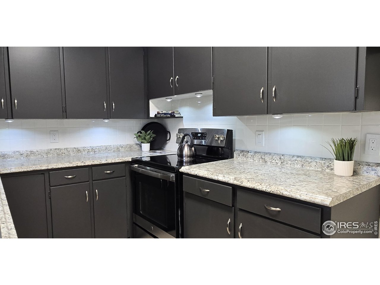 613 Skyline Drive Fort Collins, CO 80521 - Photo 8 of 19 a kitchen with a sink and cabinets