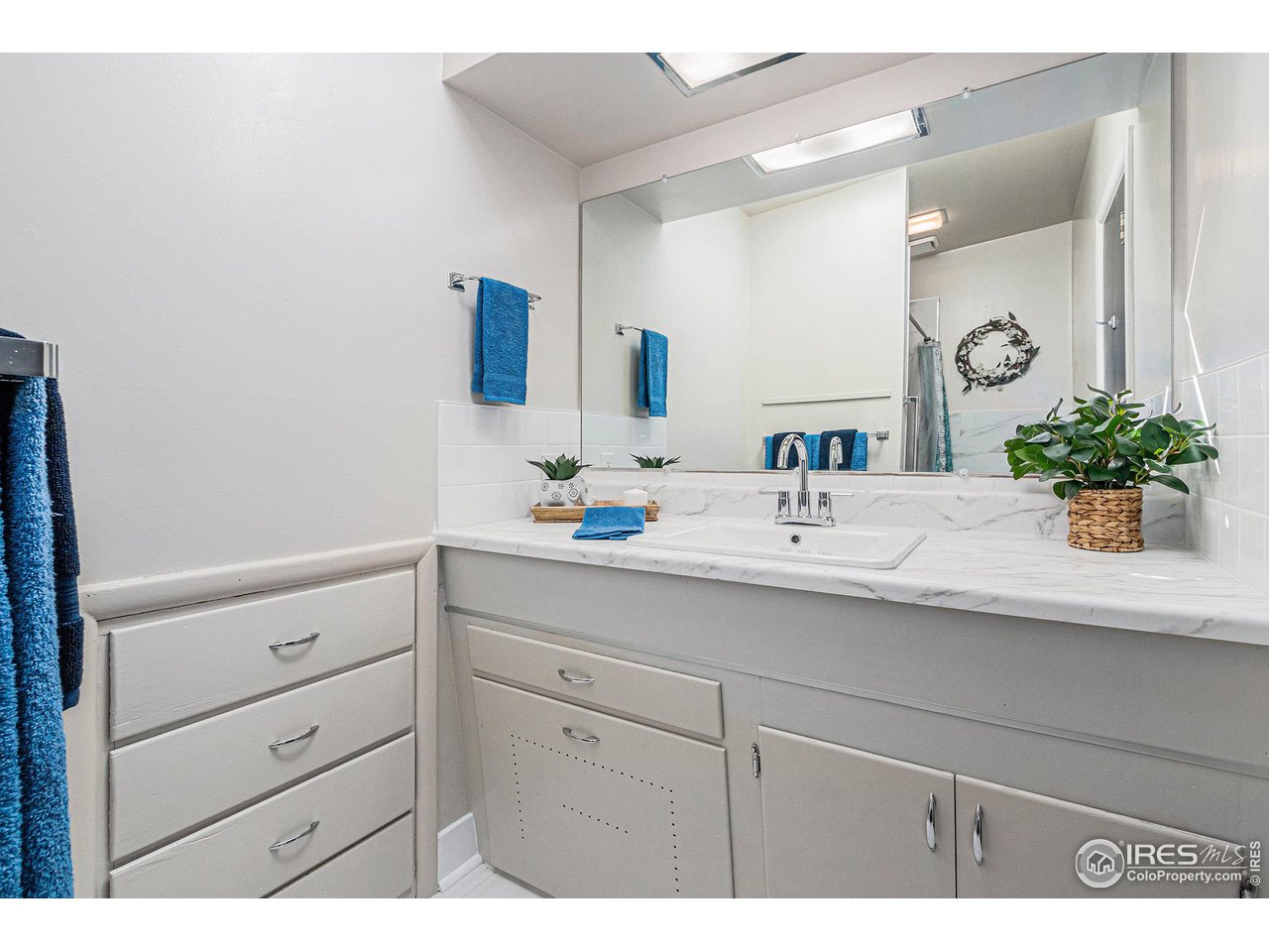 613 Skyline Drive Fort Collins, CO 80521 - Photo 9 of 19 a bathroom with a sink and a mirror
