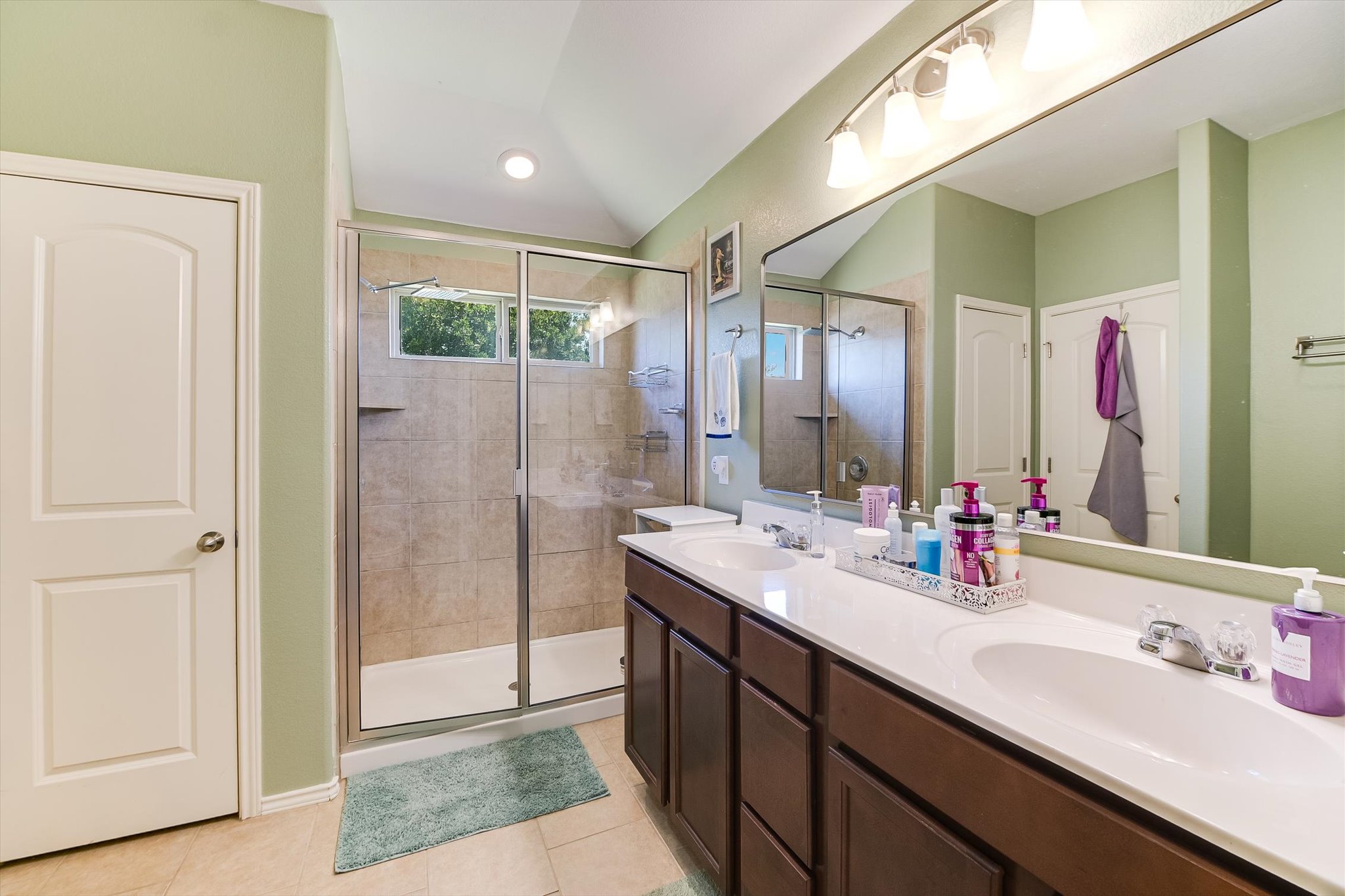 536 Dragon Ridge Road Buda, TX 78610 - Photo 14 of 20 Double vanity with white undermount sinks and dark wood-finish cabinetry