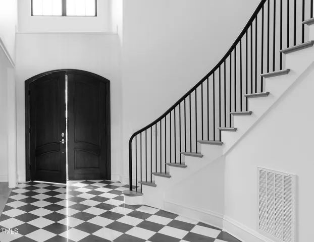 a view of a door with wooden floor and stairs