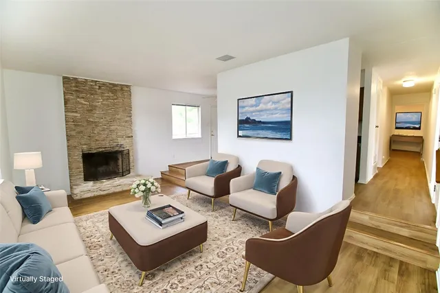 a living room with furniture and a fireplace