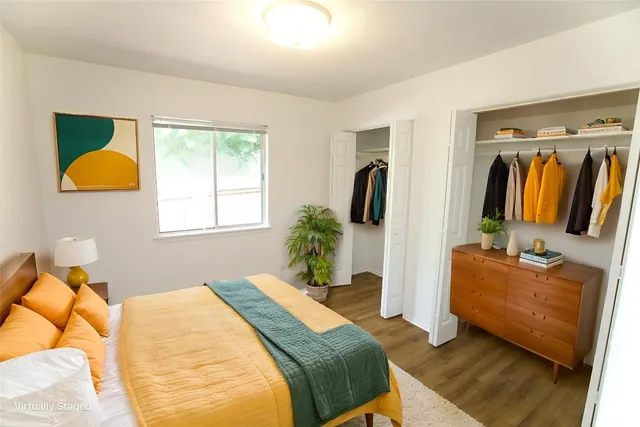 a bedroom with a bed couch and a window