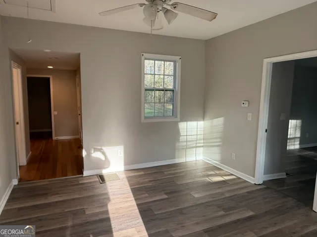 a view of a room with wooden floor and window