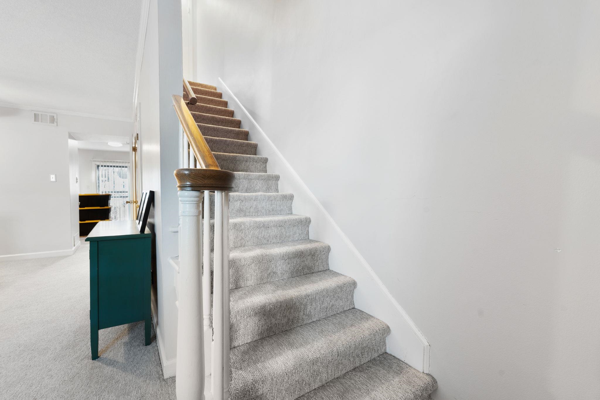 5726 Quince Road, Unit 9 Memphis, TN 38119 - Photo 11 of 18 Stairs with crown molding and carpet floors