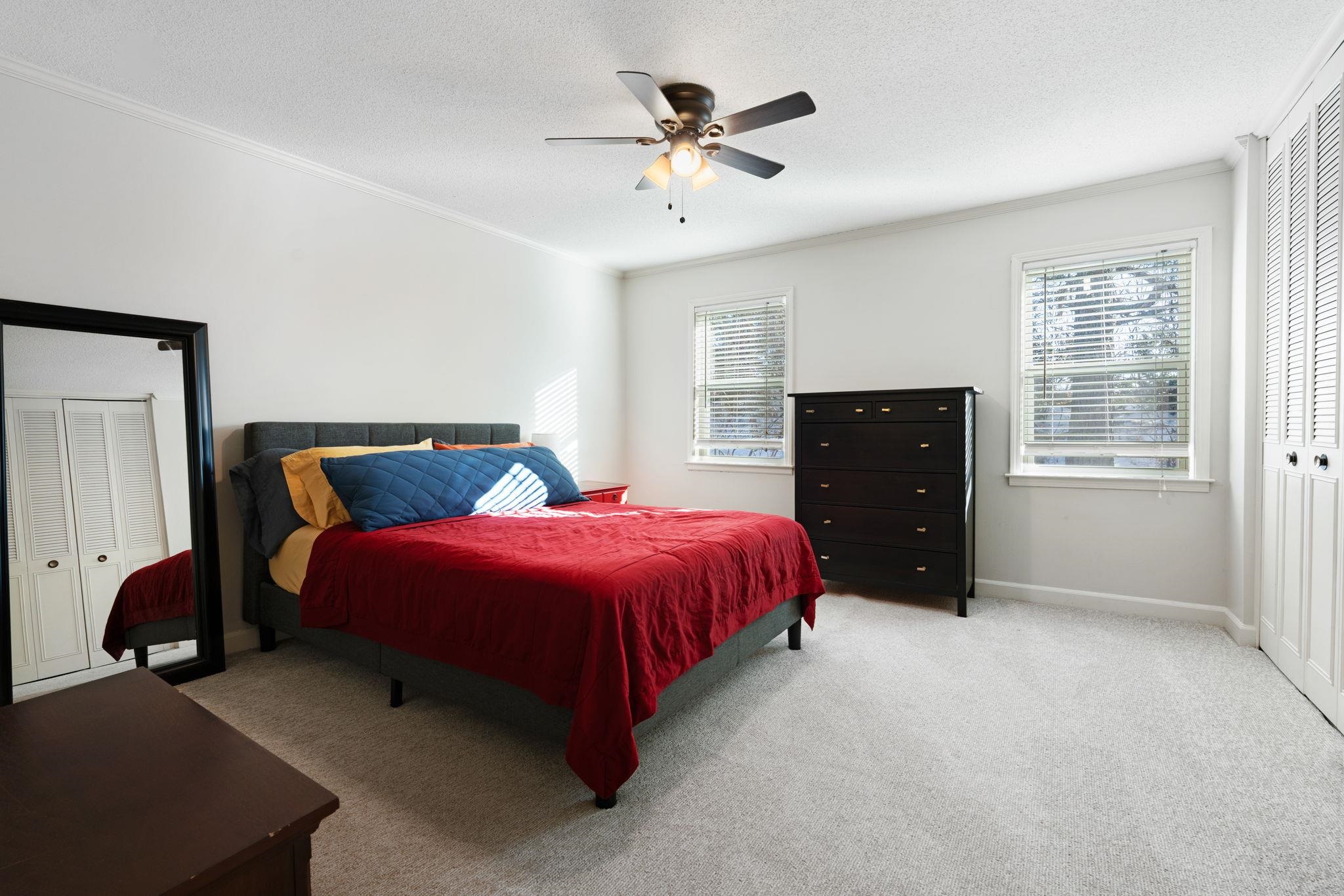 5726 Quince Road, Unit 9 Memphis, TN 38119 - Photo 13 of 18 Bedroom with a closet, light colored carpet, a ceiling fan, a textured ceiling, and crown molding