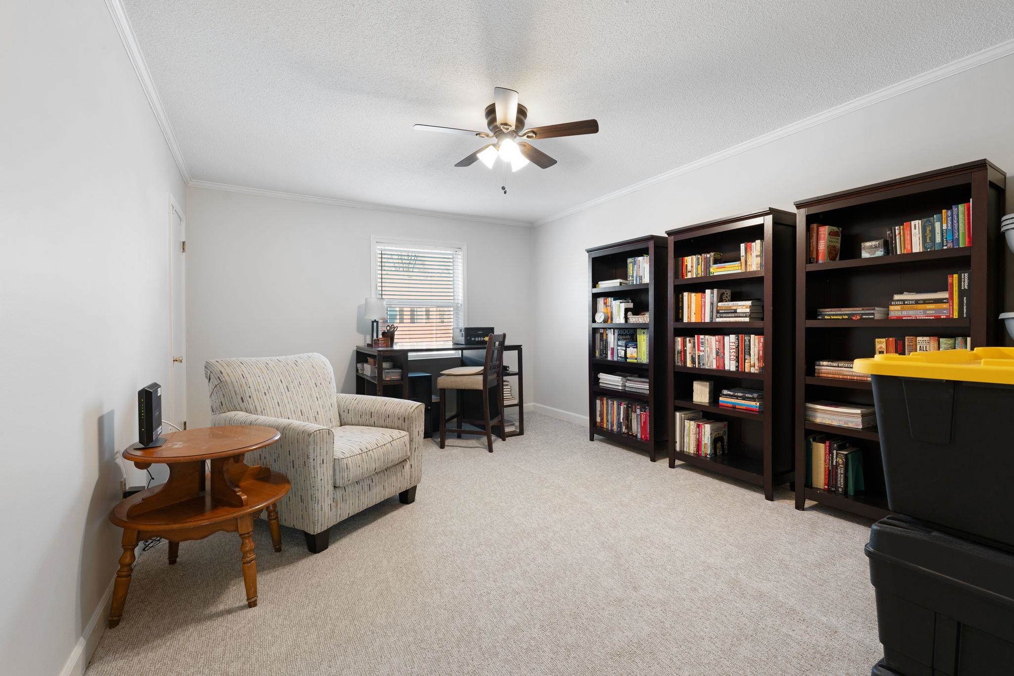 5726 Quince Road, Unit 9 Memphis, TN 38119 - Photo 15 of 18 Living area with ceiling fan, light carpet, a desk, crown molding, and a textured ceiling