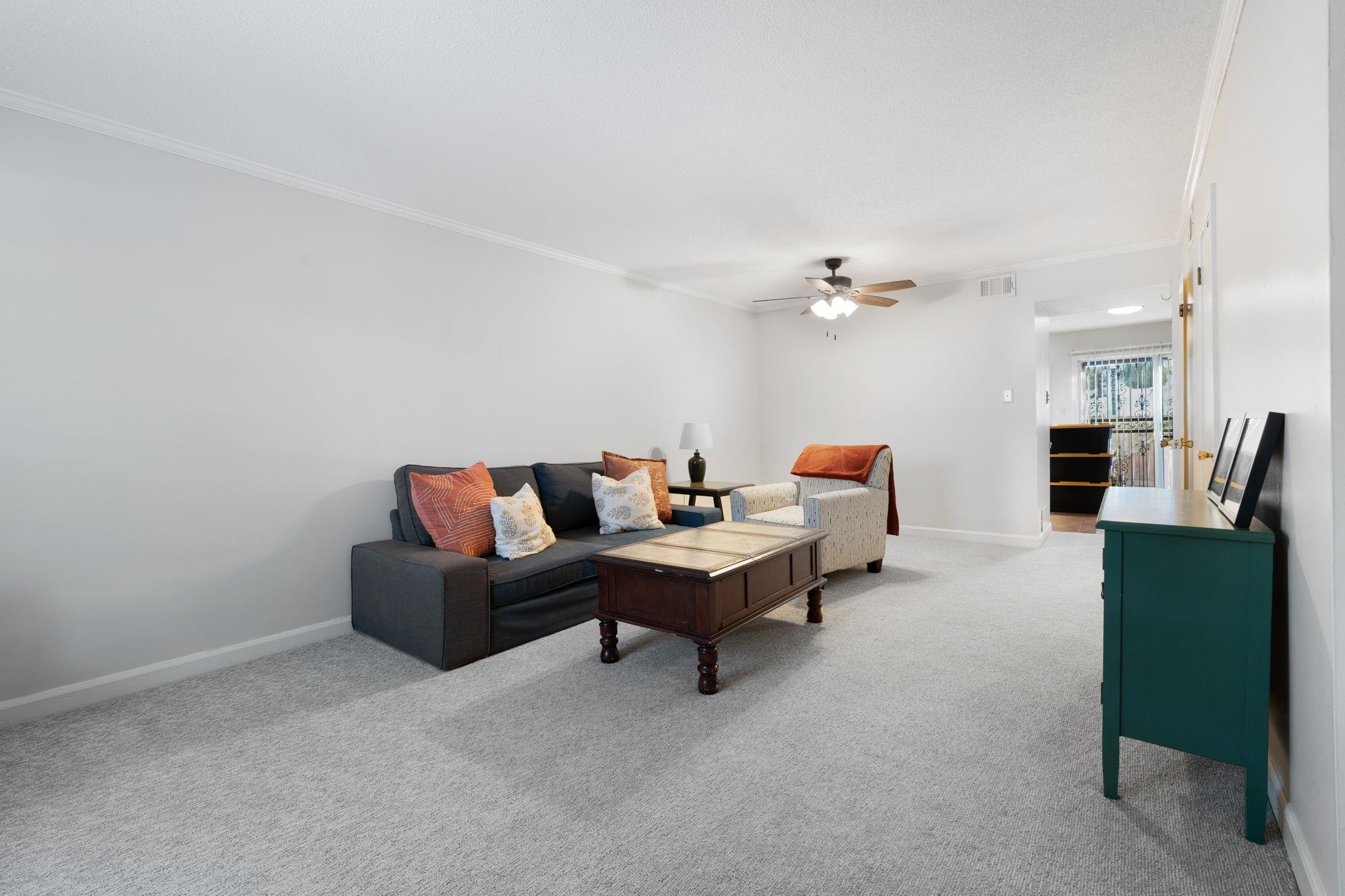 5726 Quince Road, Unit 9 Memphis, TN 38119 - Photo 6 of 21 a living room with furniture and a chandelier