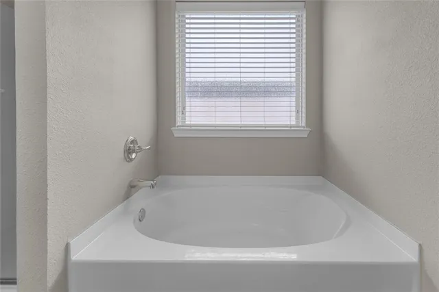 a white bath tub sitting in a bathroom