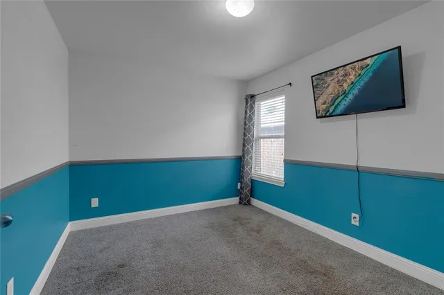 a view of room with window and ceiling fan