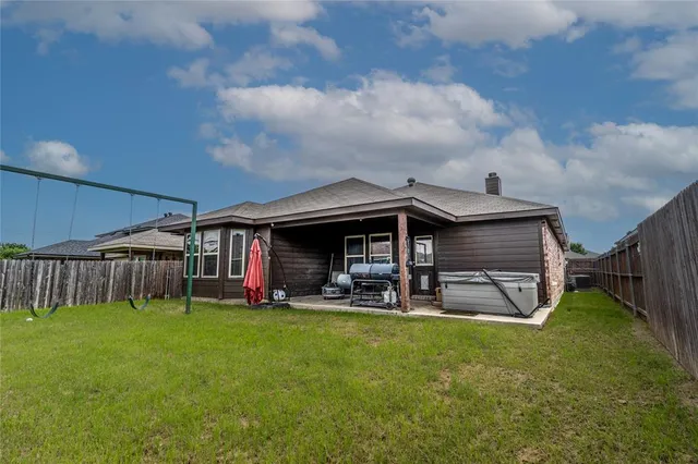 a view of a house with a yard and sitting area