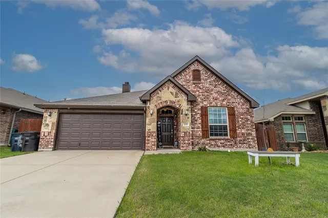 a front view of house with a garden
