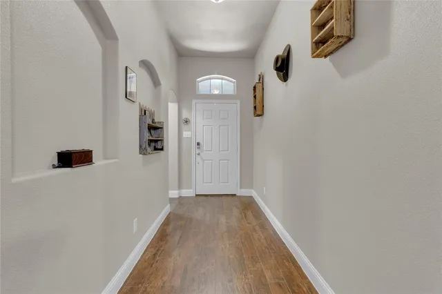 a view of a hallway with wooden floor