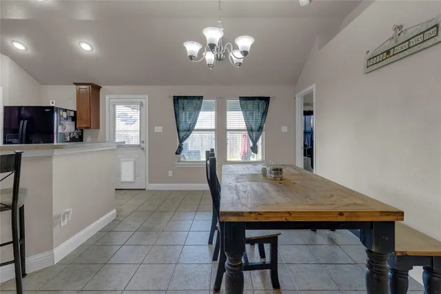 a kitchen with a table and chairs in it