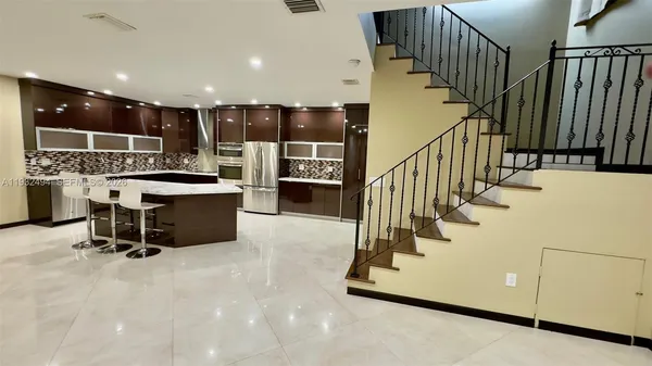 a view of entryway with wooden floor and stairs