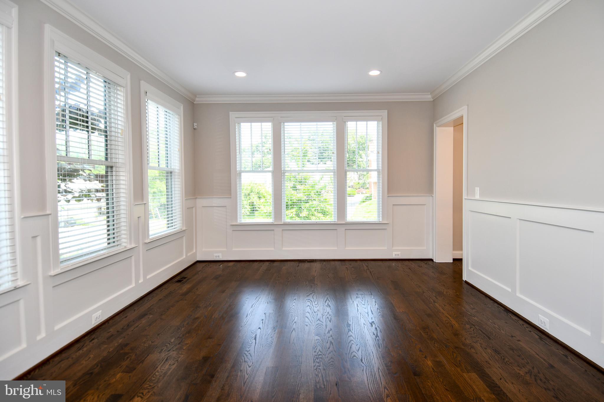 497 North Abingdon Street Arlington, VA 22203 - Photo 11 of 64 a view of an empty room with wooden floor and a window