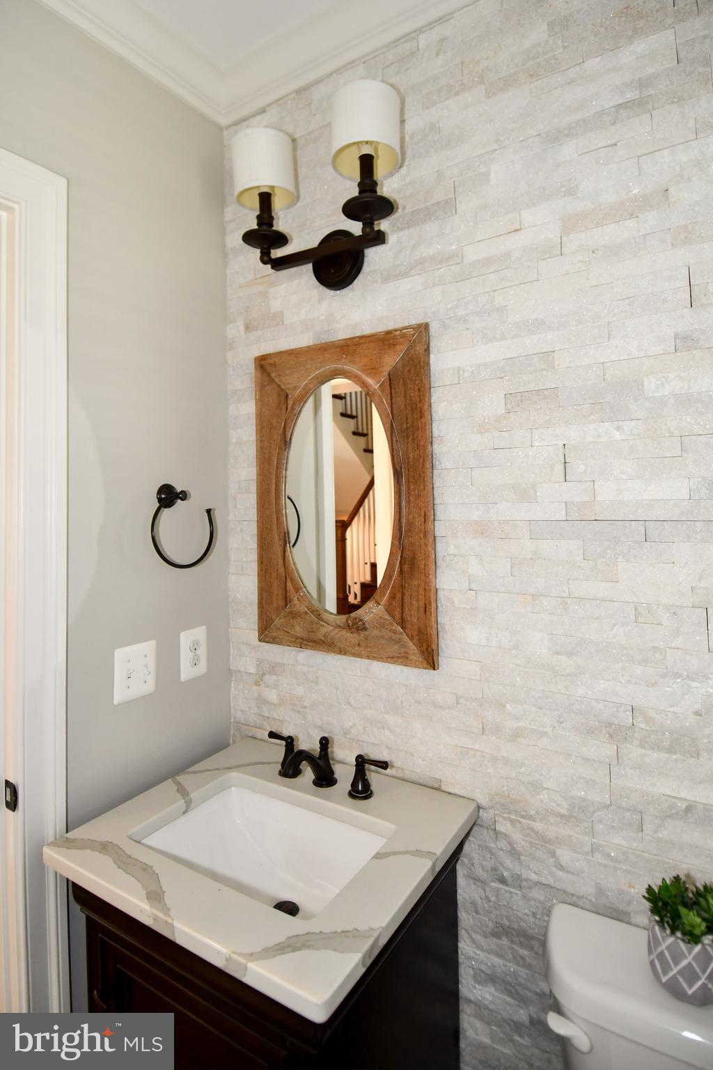 497 North Abingdon Street Arlington, VA 22203 - Photo 16 of 64 a bathroom with a sink a toilet and mirror