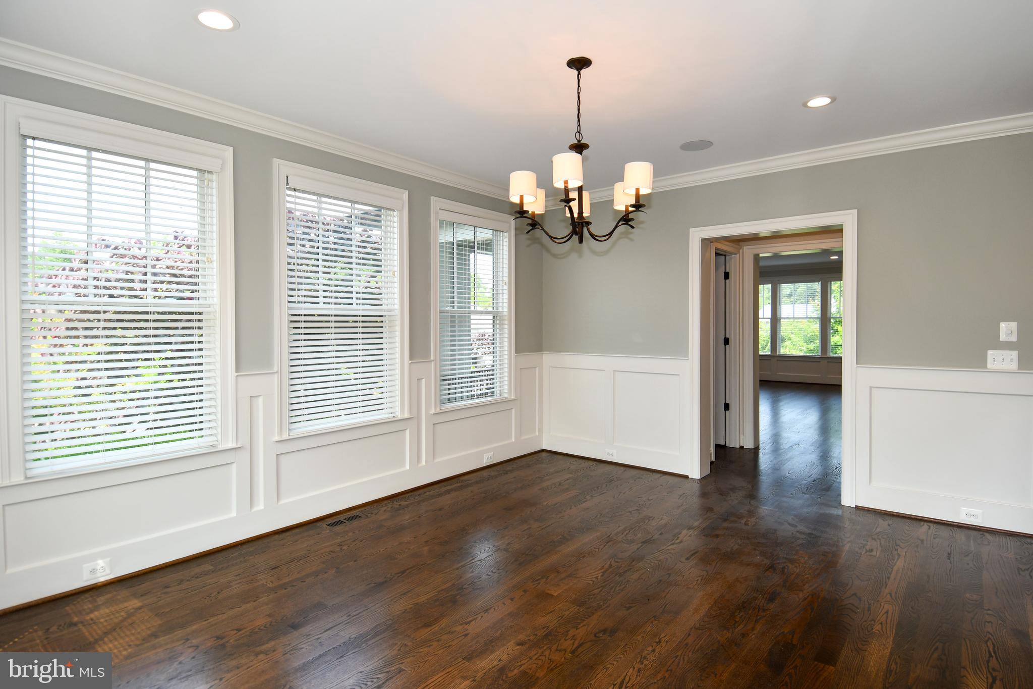 497 North Abingdon Street Arlington, VA 22203 - Photo 18 of 64 a view of a livingroom with wooden floor a ceiling fan and windows