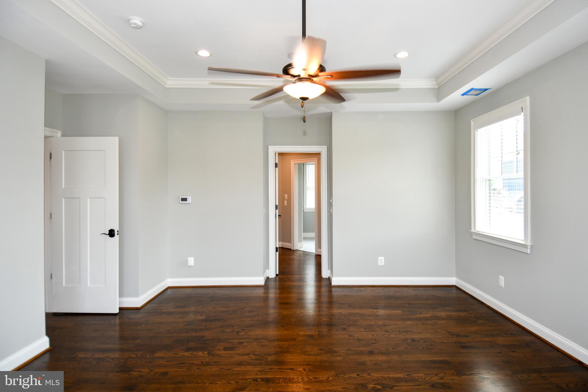 497 North Abingdon Street Arlington, VA 22203 - Photo 22 of 64 a view of an empty room with wooden floor and a window