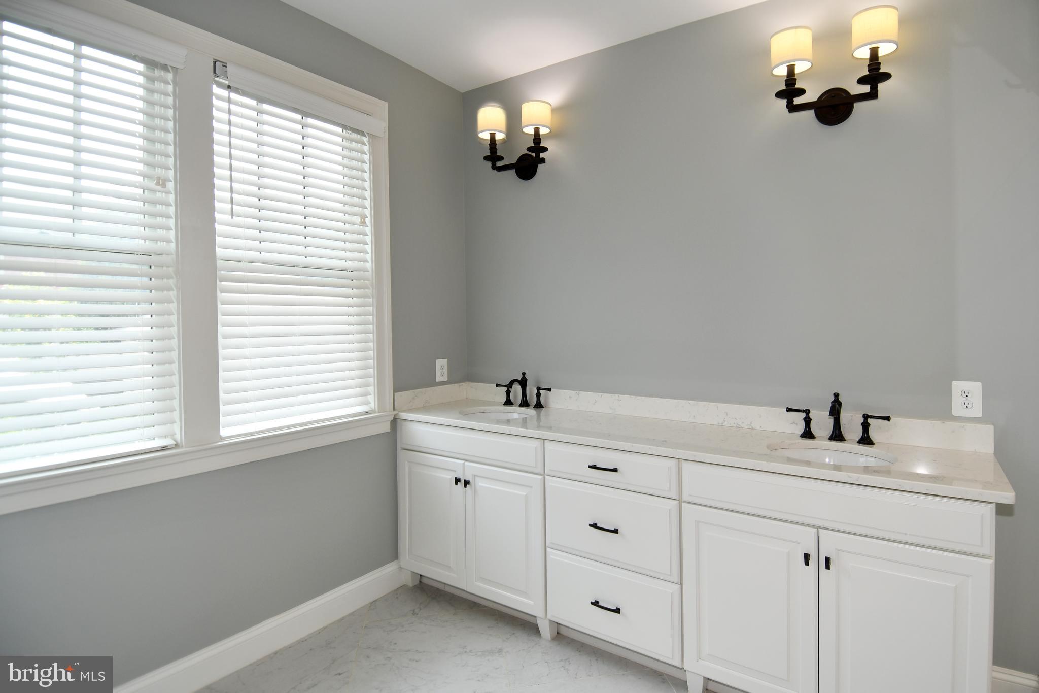 497 North Abingdon Street Arlington, VA 22203 - Photo 23 of 64 a bathroom with a double vanity sink and mirror