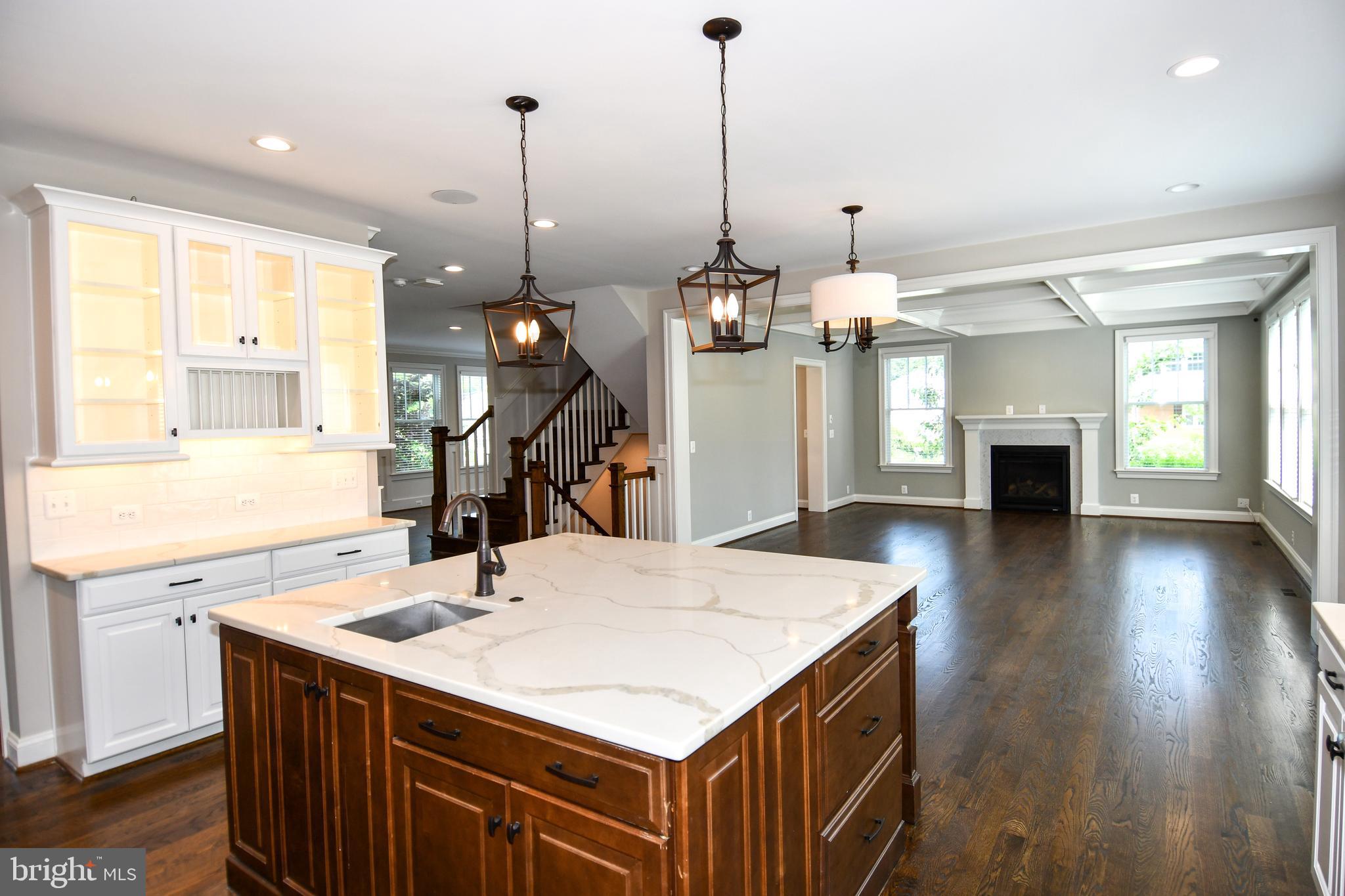 497 North Abingdon Street Arlington, VA 22203 - Photo 42 of 64 a kitchen that has a kitchen center island and a wooden floor