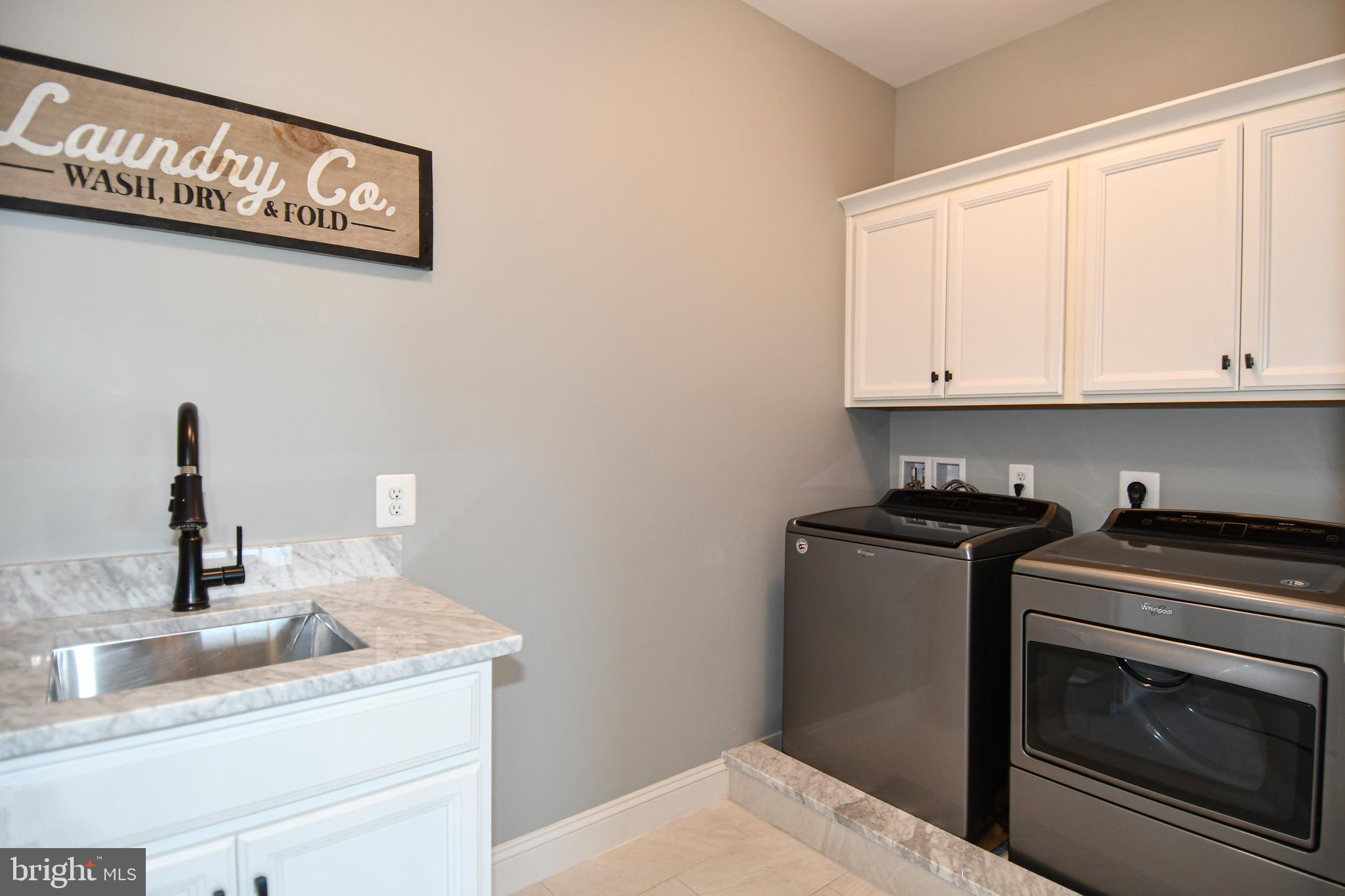 497 North Abingdon Street Arlington, VA 22203 - Photo 49 of 64 a kitchen with granite countertop a sink and cabinets