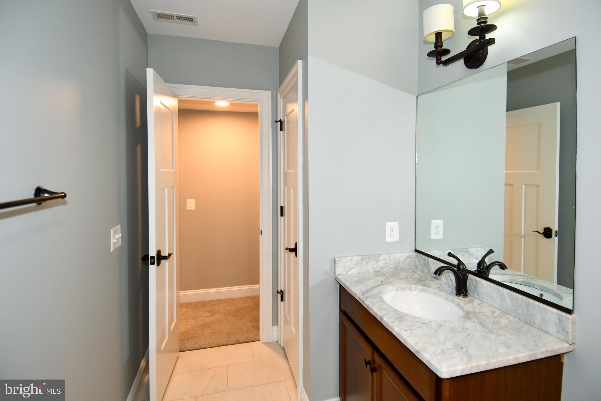 497 North Abingdon Street Arlington, VA 22203 - Photo 57 of 64 a bathroom with a sink a light fixture and a glass door