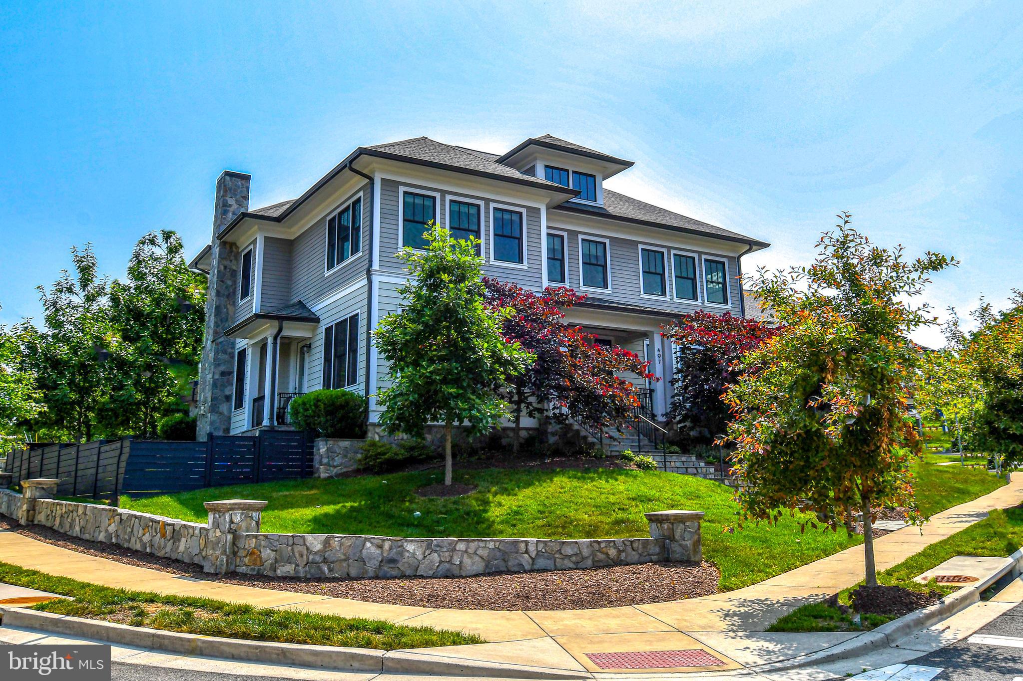 497 North Abingdon Street Arlington, VA 22203 - Photo 64 of 64 a front view of a house with a yard and potted plants