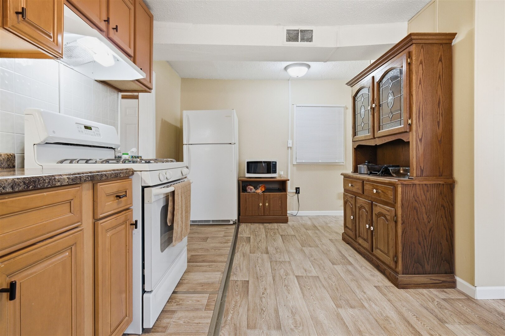 603 West Chestnut Street Bloomington, IL 61701 - Photo 16 of 24 a kitchen with cabinets stainless steel appliances and wooden floor