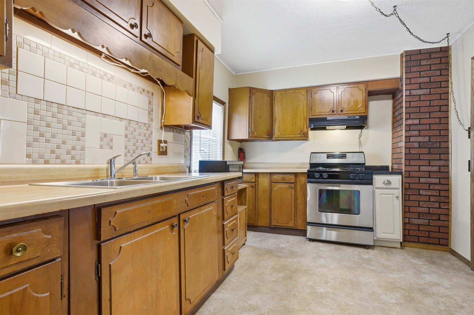 603 West Chestnut Street Bloomington, IL 61701 - Photo 6 of 24 a kitchen with granite countertop a sink stainless steel appliances and cabinets
