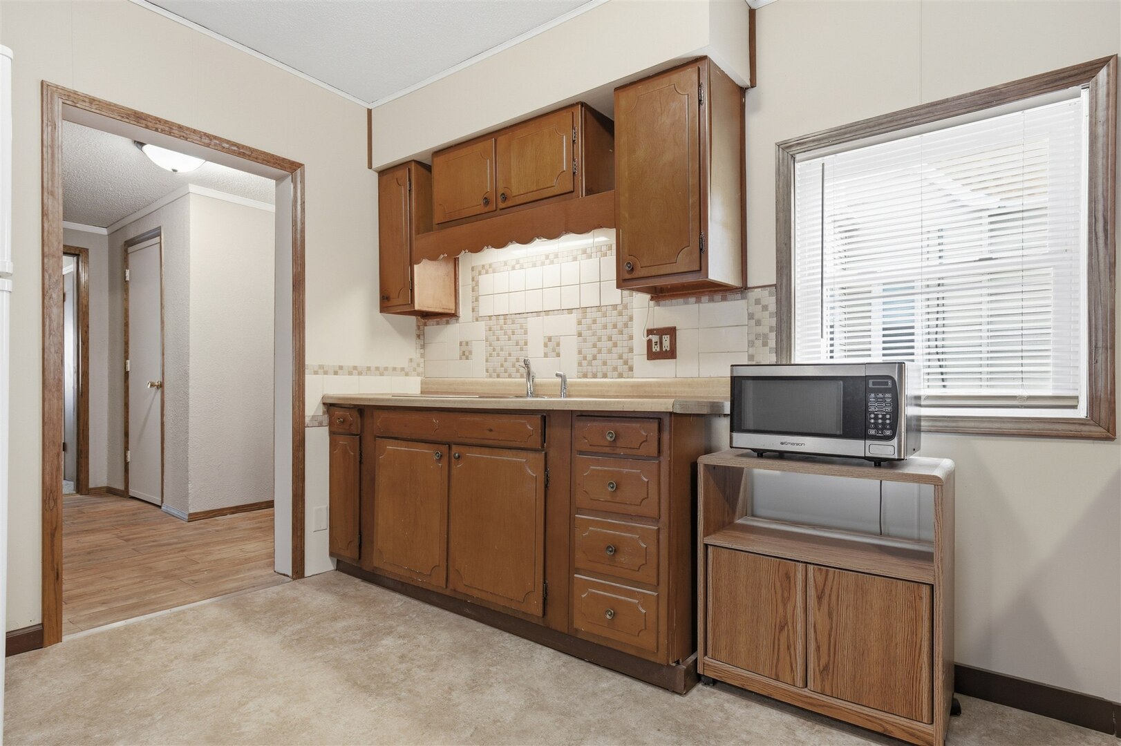 603 West Chestnut Street Bloomington, IL 61701 - Photo 7 of 24 a kitchen with sink a microwave and cabinets