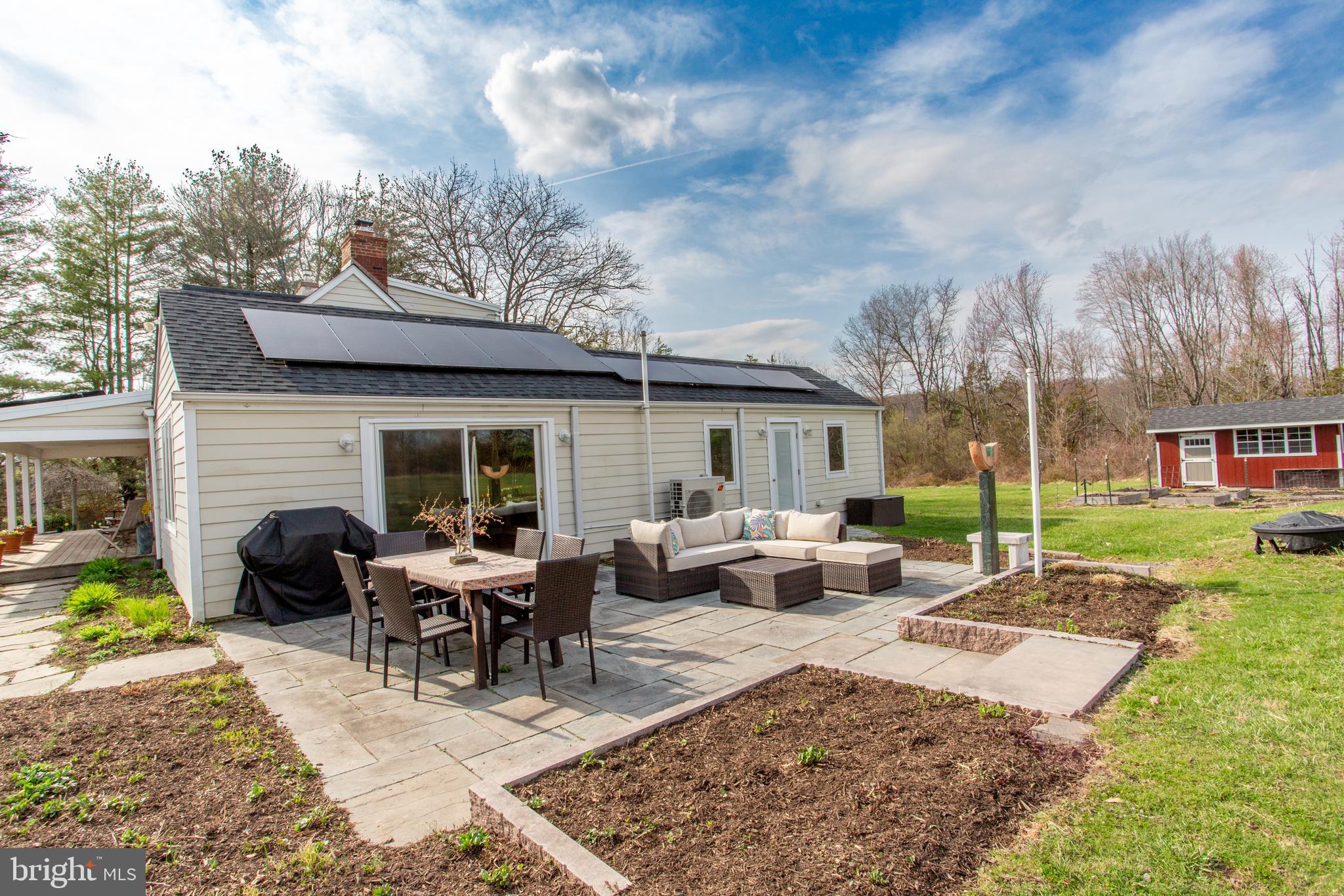 1714-linvale-harbourton R Linvale Harbourton Road Hopewell, NJ 08525 - Photo 23 of 46 a view of a house with backyard sitting area and garden