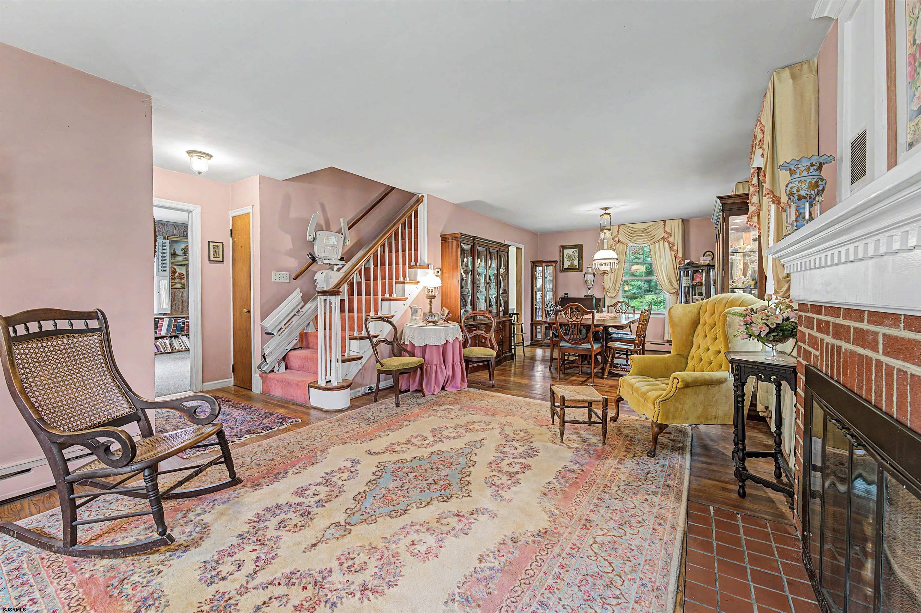 144 Pitney Road Absecon, NJ 08201 - Photo 14 of 47 a living room with furniture a rug and a chandelier