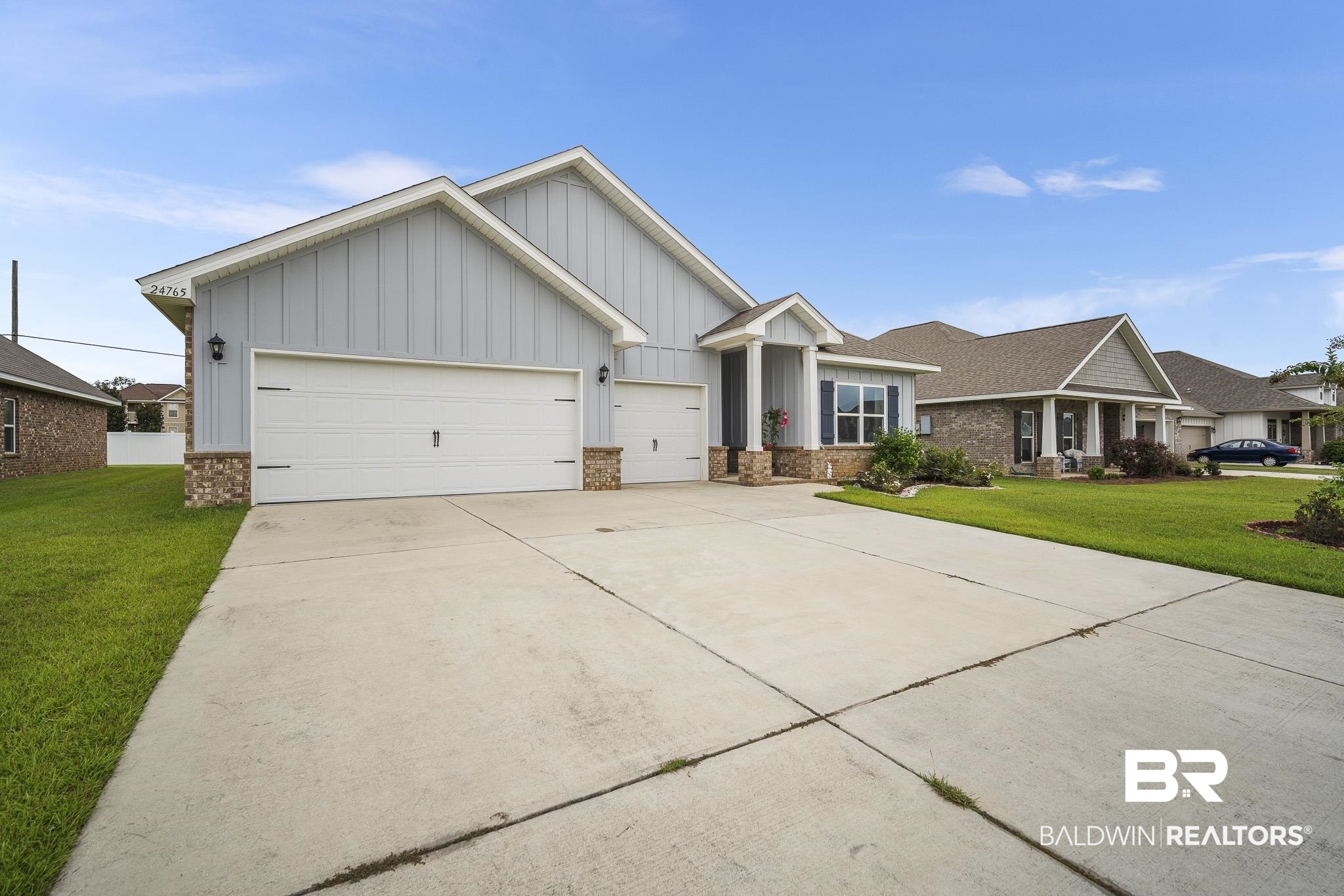 24765 Spectacular Bid Loop Daphne, AL 36526 - Photo 3 of 45 View of front of home featuring a garage and a front yard