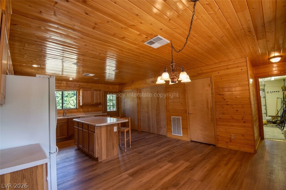 1129 East Ponderosa Road Hatch, UT 84735 - Photo 13 of 47 Rich wood plank ceilings and matching walls define this warm open-concept kitchen space.