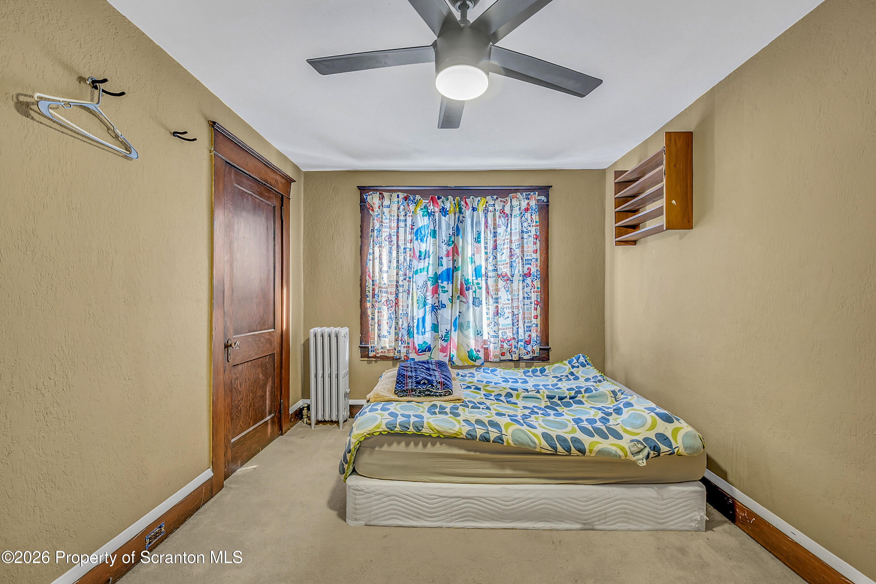 2309 Ash Street Scranton, PA 18510 - Photo 25 of 46 a bedroom with a bed and a chandelier