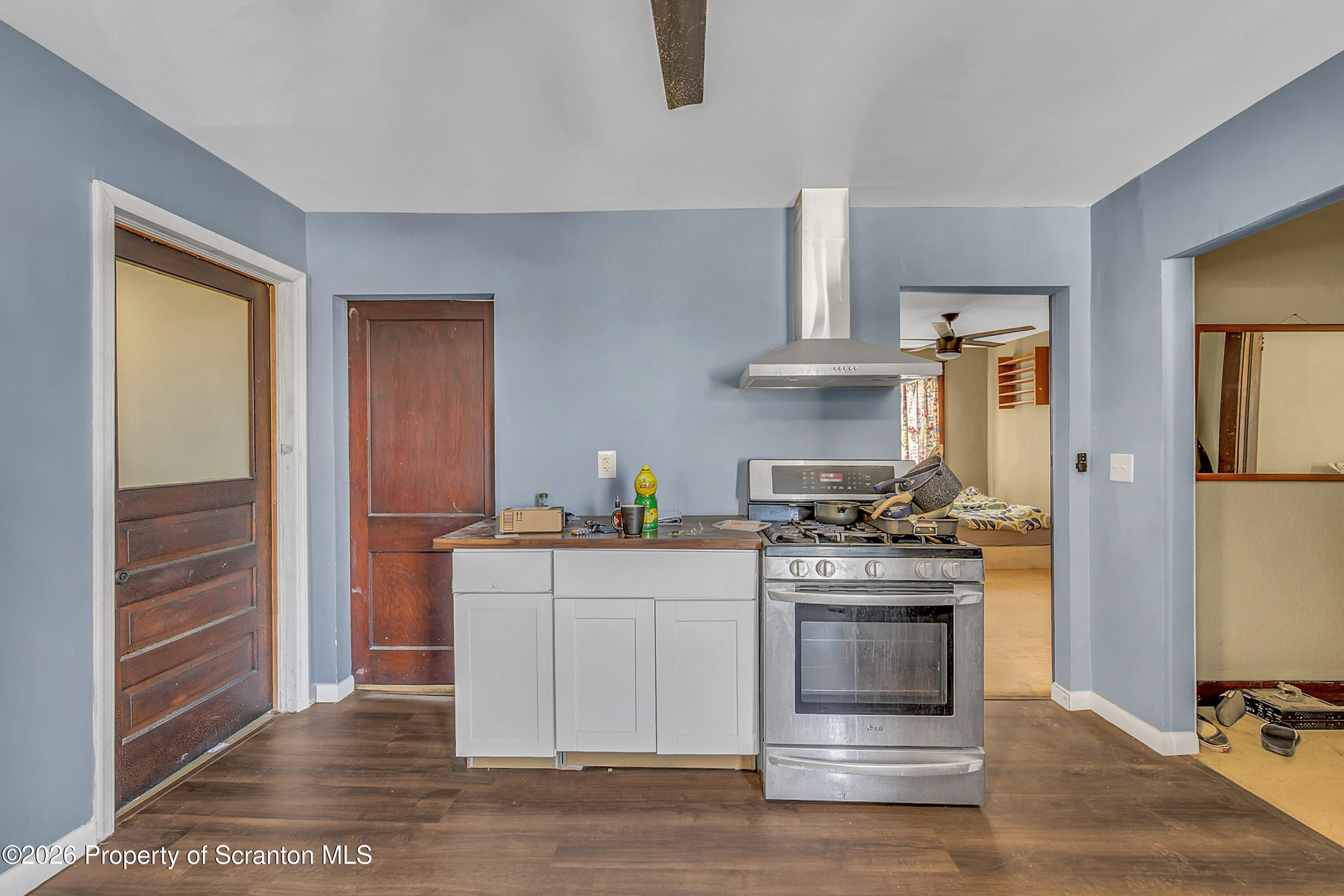 2309 Ash Street Scranton, PA 18510 - Photo 31 of 46 a kitchen with stainless steel appliances a stove and white cabinets